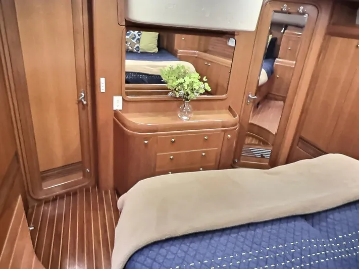 Celebrate Yacht Photos Pics Luxurious 2003 Taswell 58 yacht interior with elegant wood finish and cozy bedding.