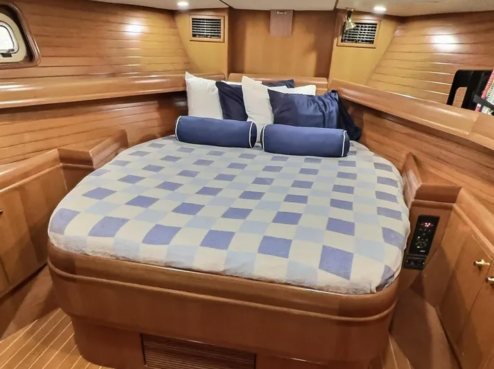 Celebrate Yacht Photos Pics Luxurious cabin interior of 2003 Taswell 58 yacht with cozy bed and wooden finish.
