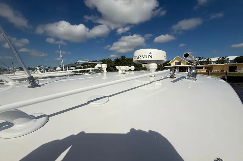  Yacht Photos Pics 2013 Intrepid 327 Cuddy boat with Garmin radar under a clear blue sky.