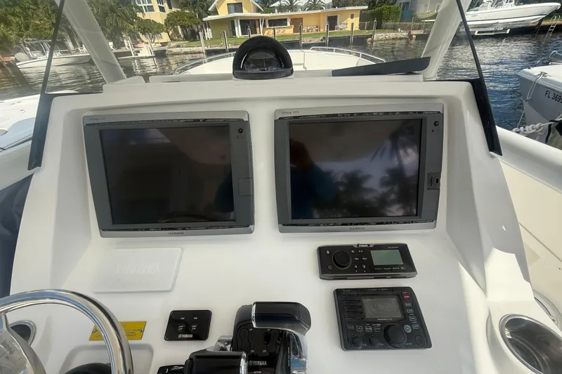  Yacht Photos Pics Control panel of a 2013 Intrepid 327 Cuddy boat with navigation screens.