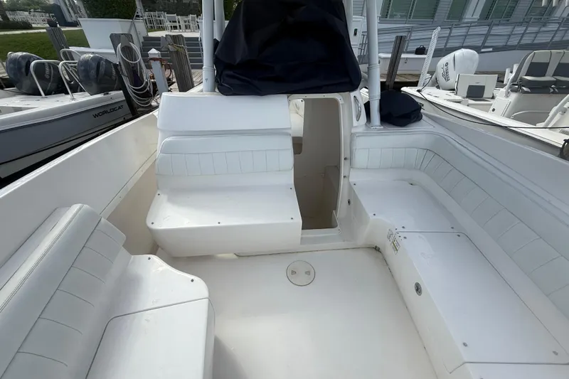  Yacht Photos Pics 2013 Intrepid 327 Cuddy boat interior with white seating and open cabin entrance.