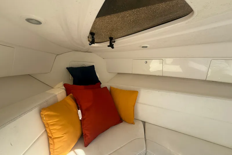  Yacht Photos Pics 2013 Intrepid 327 Cuddy cabin interior with colorful cushions and white seating.