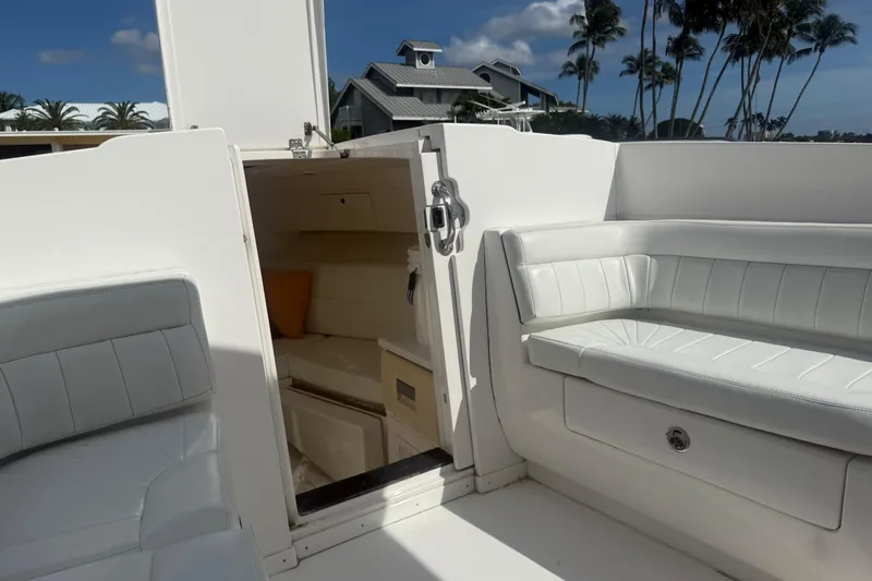  Yacht Photos Pics 2013 Intrepid 327 Cuddy interior with white seating and open cabin door.