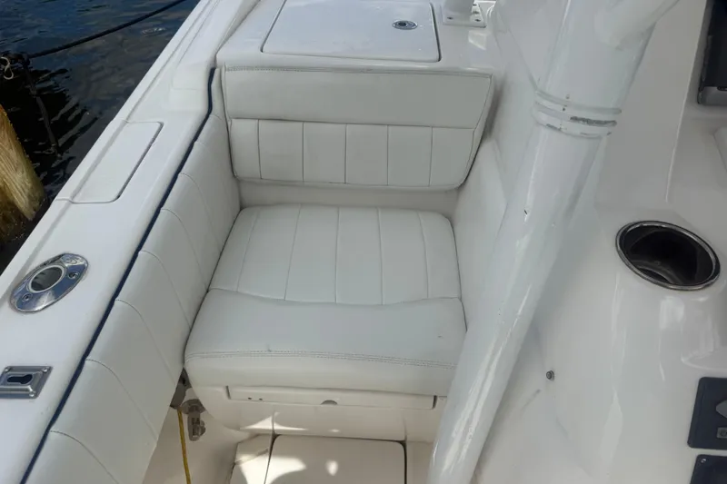  Yacht Photos Pics White cushioned seating on 2013 Intrepid 327 Cuddy boat, dockside view.