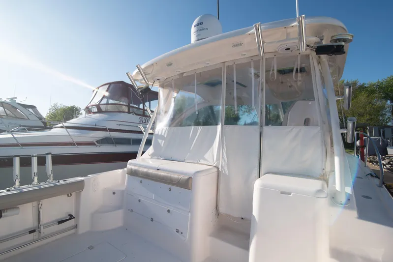  Yacht Photos Pics 2015 Pursuit OS 345 Offshore boat with covered cockpit and fishing rod holders.