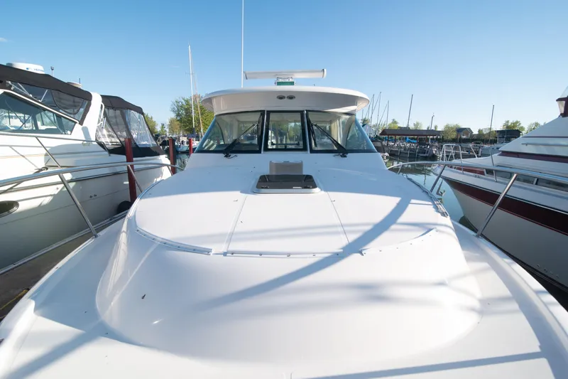  Yacht Photos Pics 2015 Pursuit OS 345 Offshore boat docked at marina under clear blue sky.