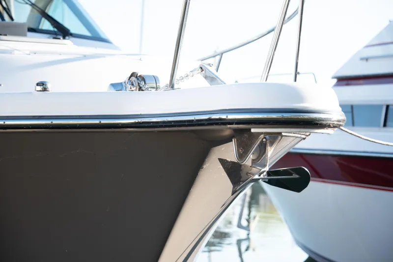  Yacht Photos Pics 2015 Pursuit OS 345 Offshore boat bow with anchor, docked in sunlight.
