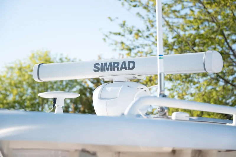  Yacht Photos Pics Simrad radar on 2015 Pursuit OS 345 Offshore boat against a clear sky.