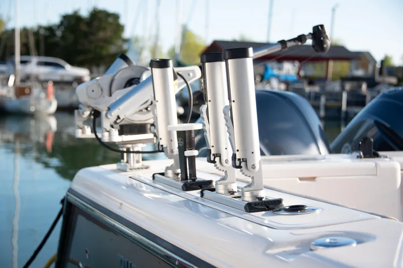  Yacht Photos Pics 2015 Pursuit OS 345 Offshore boat with fishing rod holders in a marina setting.