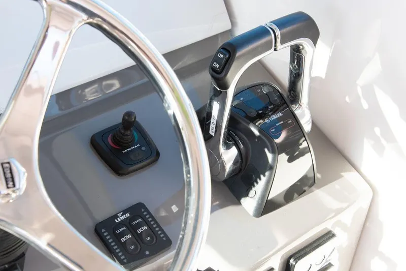  Yacht Photos Pics Control panel of 2015 Pursuit OS 345 Offshore boat with steering wheel and throttle levers.