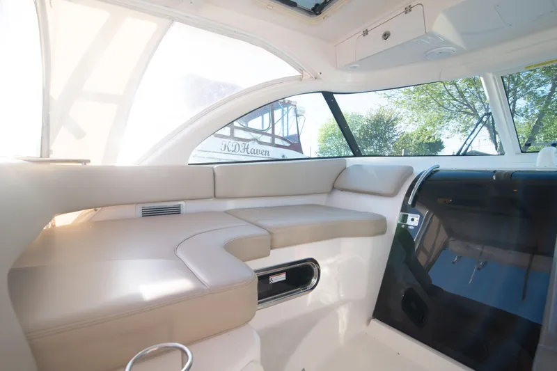  Yacht Photos Pics Interior of 2015 Pursuit OS 345 Offshore boat with beige seating and large windows.