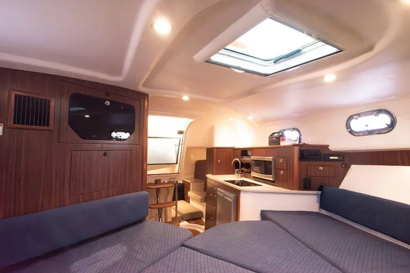  Yacht Photos Pics Interior of 2015 Pursuit OS 345 Offshore boat with modern kitchen and seating area.