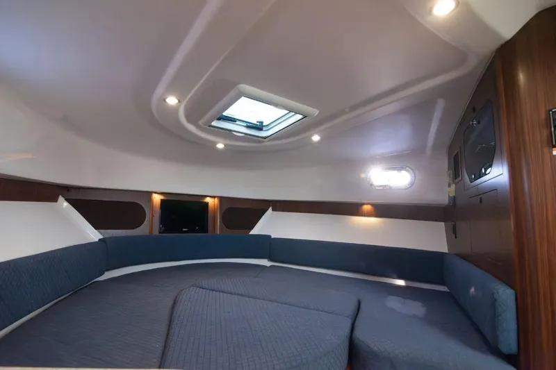  Yacht Photos Pics 2015 Pursuit OS 345 Offshore cabin interior with seating and skylight.