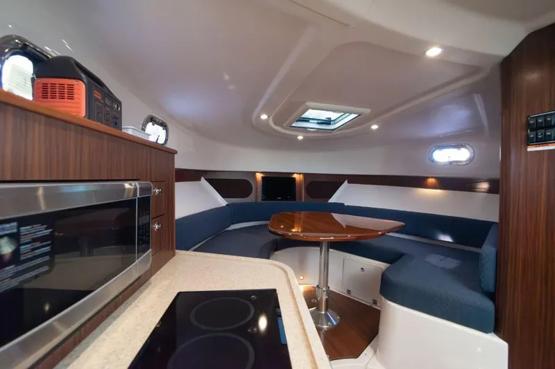  Yacht Photos Pics Interior of 2015 Pursuit OS 345 Offshore boat with modern kitchen and seating area.