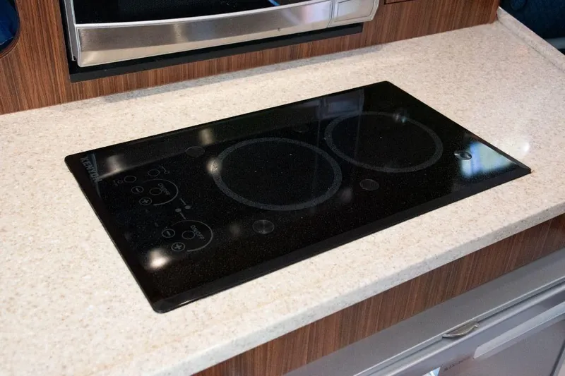  Yacht Photos Pics Built-in electric cooktop on 2015 Pursuit OS 345 Offshore boat kitchen counter.