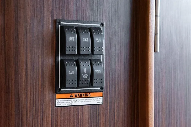  Yacht Photos Pics Control panel on 2015 Pursuit OS 345 Offshore boat with labeled switches and warning sign.