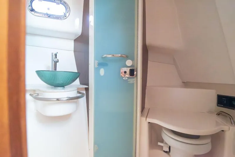  Yacht Photos Pics 2015 Pursuit OS 345 Offshore boat bathroom with modern sink and toilet.