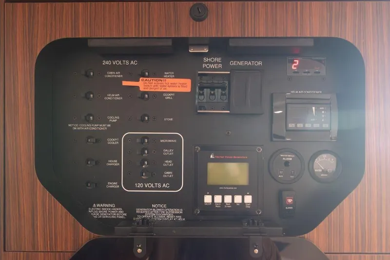  Yacht Photos Pics Electrical control panel of a 2015 Pursuit OS 345 Offshore boat, featuring various switches and gauges.