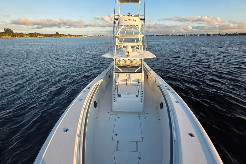 T/t One More Day Yacht Photos Pics 2019 Yellowfin 42 Offshore boat on calm water at sunset.