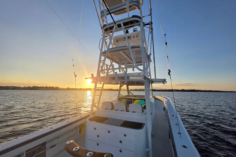 T/t One More Day Yacht Photos Pics 2019 Yellowfin 42 Offshore boat at sunset on calm waters.