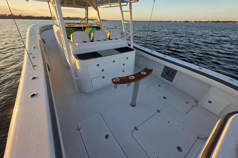 T/t One More Day Yacht Photos Pics 2019 Yellowfin 42 Offshore boat interior, featuring spacious deck and seating, on calm waters.