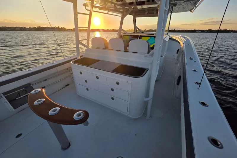 T/t One More Day Yacht Photos Pics 2019 Yellowfin 42 Offshore boat at sunset on calm waters.