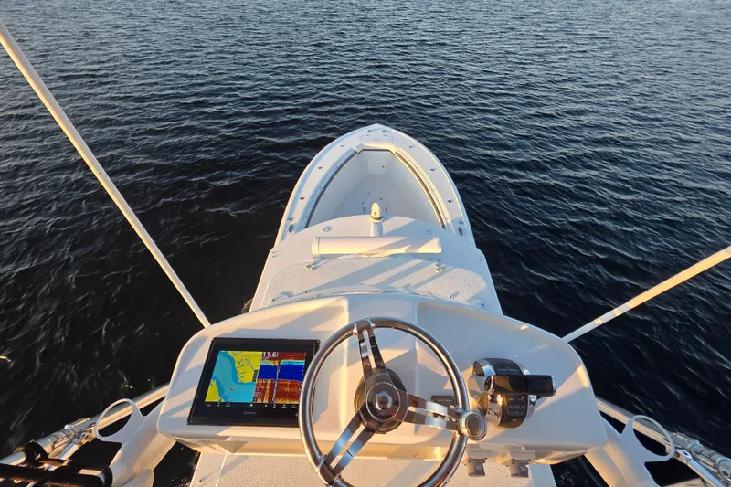 T/t One More Day Yacht Photos Pics 2019 Yellowfin 42 Offshore boat dashboard with navigation system on open water.