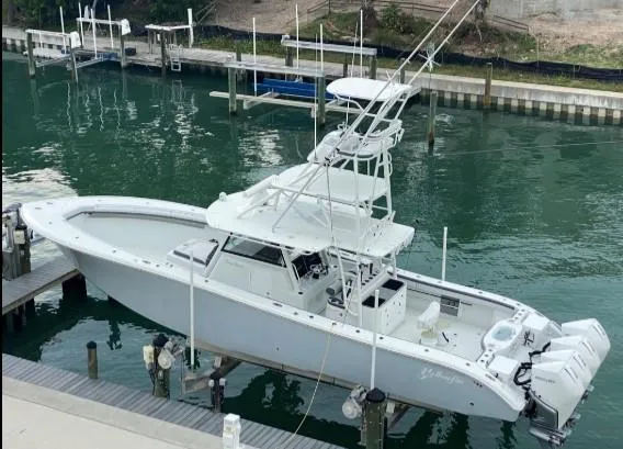 One More Day Yacht Photos Pics 2019 Yellowfin Center Console boat docked in marina, side view.