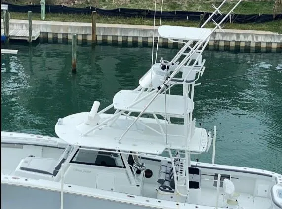 One More Day Yacht Photos Pics 2019 Yellowfin Center Console boat docked in a marina, featuring a sleek white design.