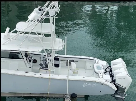 One More Day Yacht Photos Pics 2019 Yellowfin Center Console boat docked on calm water.