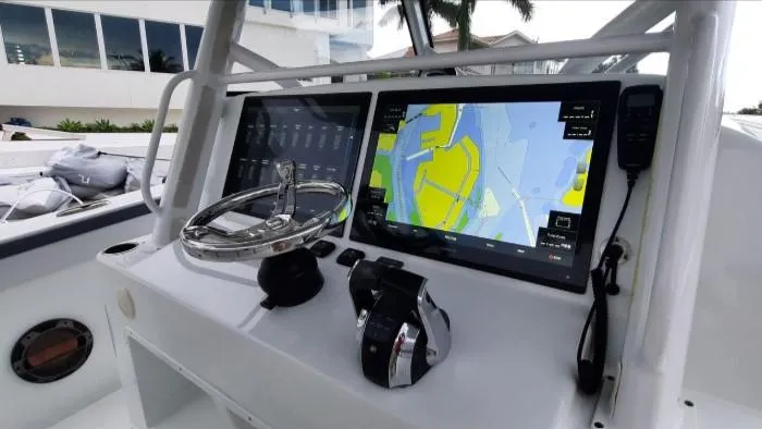 One More Day Yacht Photos Pics 2019 Yellowfin Center Console boat dashboard with navigation screens and controls.