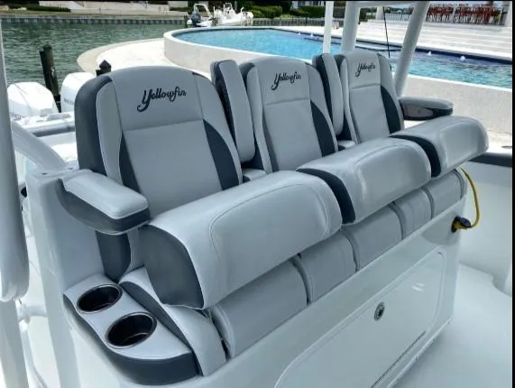 One More Day Yacht Photos Pics 2019 Yellowfin Center Console boat seats with cup holders, docked by a pool.