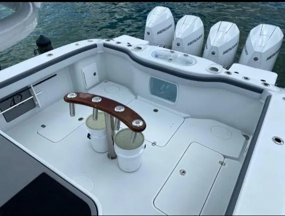 One More Day Yacht Photos Pics 2019 Yellowfin Center Console boat with multiple Mercury engines, spacious deck, and fishing rod holders.