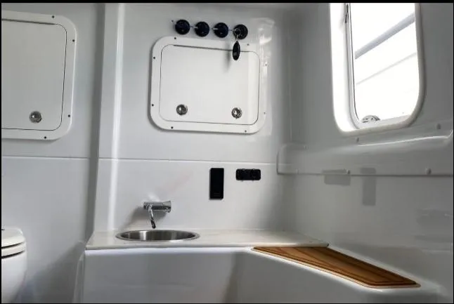 One More Day Yacht Photos Pics 2019 Yellowfin Center Console boat interior with sink and storage compartments.