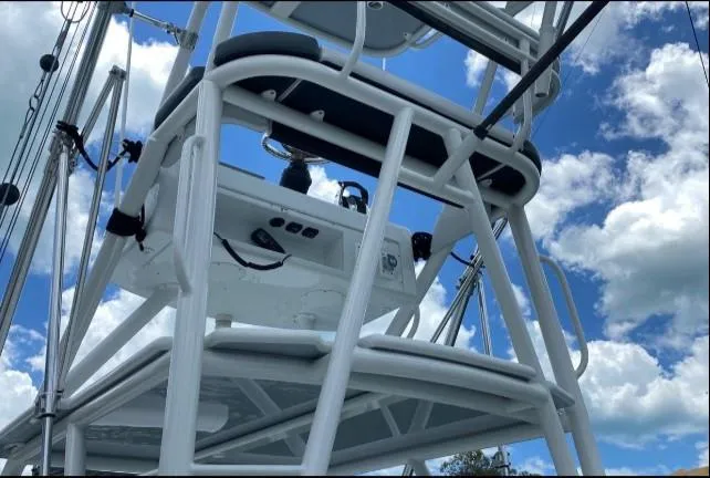 One More Day Yacht Photos Pics 2019 Yellowfin Center Console boat tower against a blue sky with clouds.