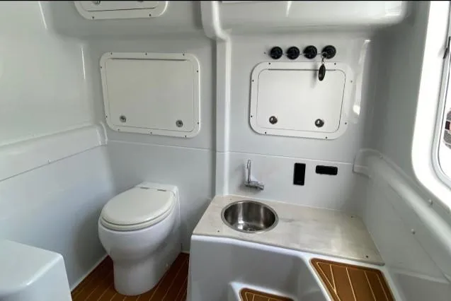 One More Day Yacht Photos Pics 2019 Yellowfin Center Console boat interior with toilet and sink.