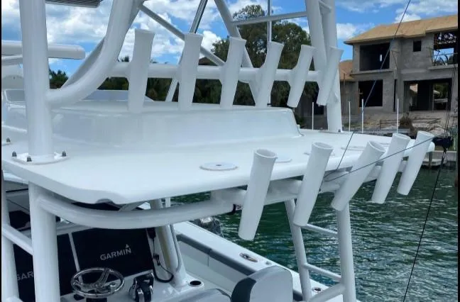 One More Day Yacht Photos Pics 2019 Yellowfin Center Console boat with rod holders and Garmin equipment, docked near waterfront homes.
