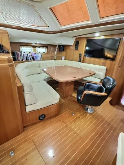 Celebrate Yacht Photos Pics Luxurious 2003 Taswell 58 yacht interior with plush seating and elegant wood finishes.