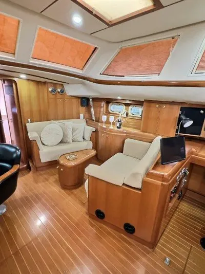 Celebrate Yacht Photos Pics Luxurious 2003 Taswell 58 yacht interior with elegant wood finish and comfortable seating.