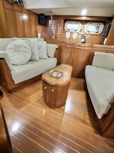 Celebrate Yacht Photos Pics Luxurious 2003 Taswell 58 yacht interior with elegant wood finish and cozy seating area.