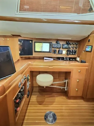 Celebrate Yacht Photos Pics Navigation station of 2003 Taswell 58 yacht with wooden interior and advanced equipment.