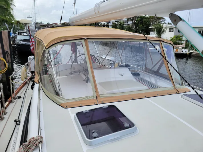 Celebrate Yacht Photos Pics Sailboat Taswell 58, 2003 model, docked with tan canopy and clear windows.