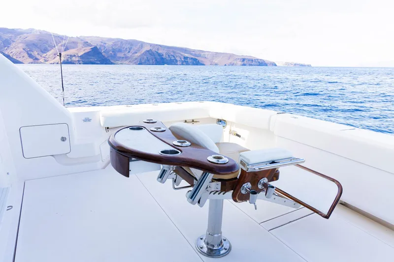 Pecado Yacht Photos Pics 2006 Bertram 510 Convertible yacht deck with fishing chair, ocean view, and distant mountains.
