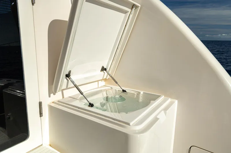 Pecado Yacht Photos Pics 2006 Bertram 510 Convertible yacht with open storage compartment on deck.