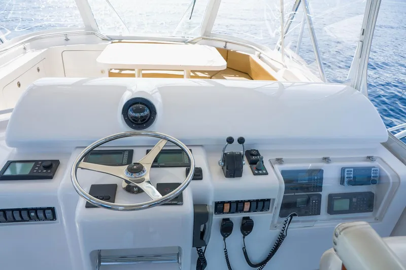 Pecado Yacht Photos Pics 2006 Bertram 510 Convertible yacht helm with steering wheel and navigation controls.