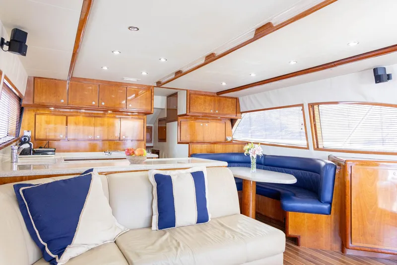 Pecado Yacht Photos Pics Luxurious interior of a 2006 Bertram 510 Convertible yacht with elegant wood finishes.