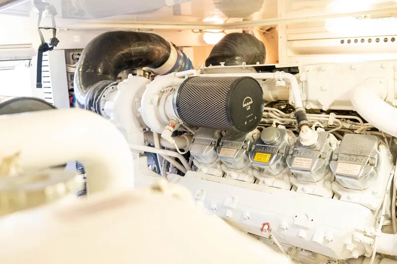 Pecado Yacht Photos Pics Engine room of a 2006 Bertram 510 Convertible yacht, showcasing detailed machinery components.