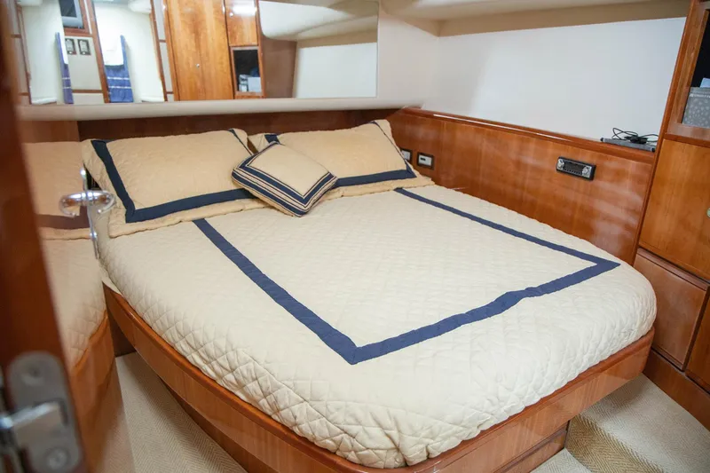 Pecado Yacht Photos Pics Luxurious bedroom interior of 2006 Bertram 510 Convertible yacht with elegant bedding.