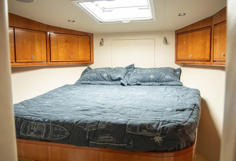 Pecado Yacht Photos Pics Luxurious cabin interior of 2006 Bertram 510 Convertible yacht with cozy bedding.