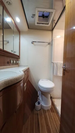 Pecado Yacht Photos Pics 2006 Bertram 510 Convertible yacht bathroom with wood flooring and modern fixtures.